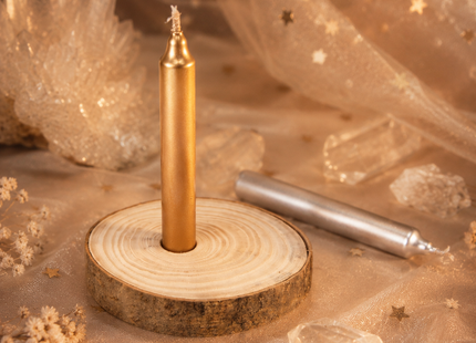 Goldene Ritualkerze auf Holzscheibe mit silberner Kerze, Kristallen und warmem Licht für Rauhnächte, Orakel und Seelenmomente.